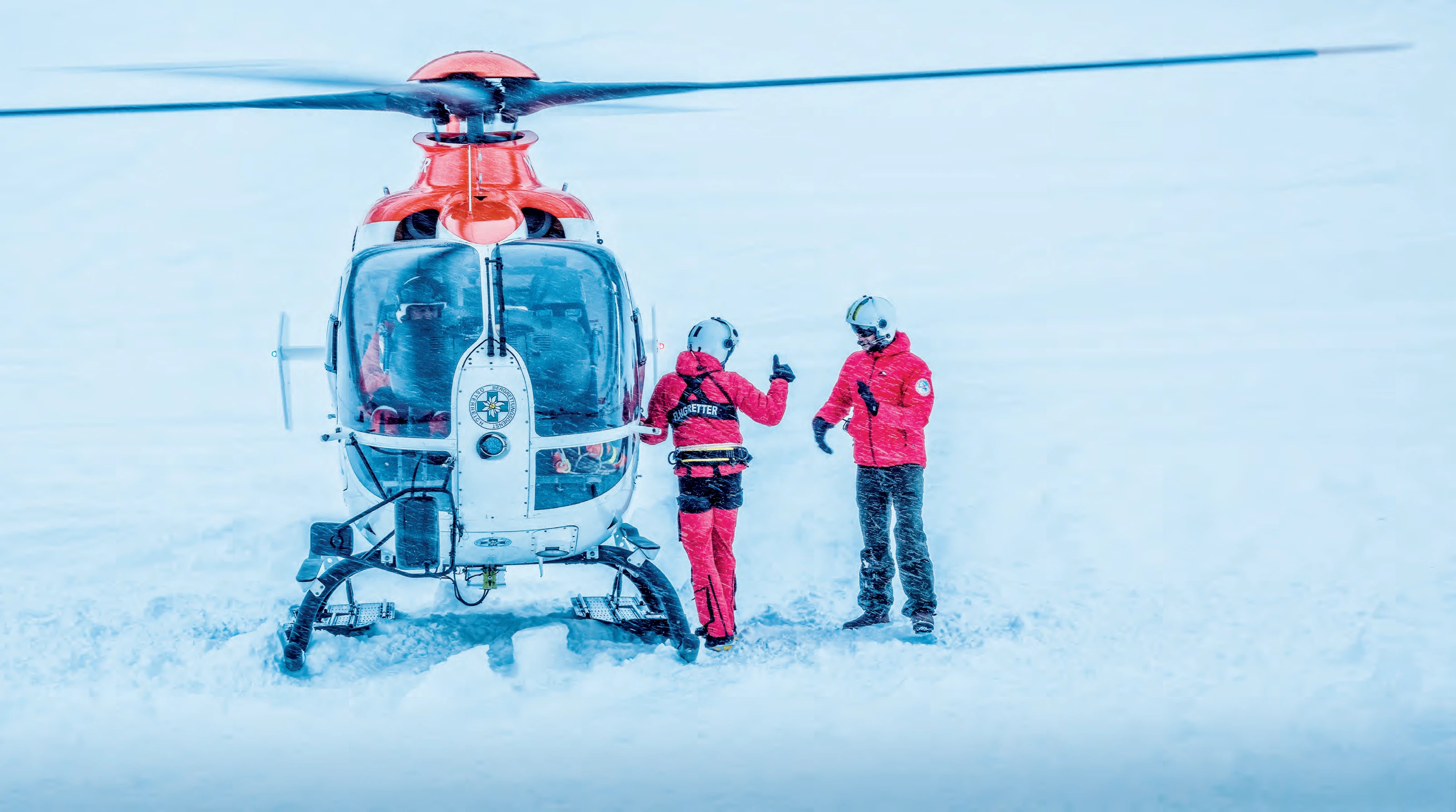 Medical helicopter operating in harsh winter conditions and snow-covered terrain
